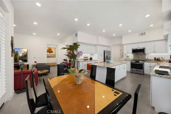 a outdoor dining space with furniture and wooden floor