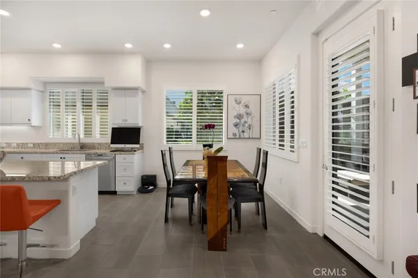 front view of a house with a chairs and table in a patio