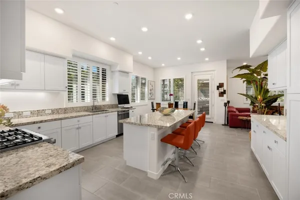 a view of a patio with couches table and chairs and potted plants