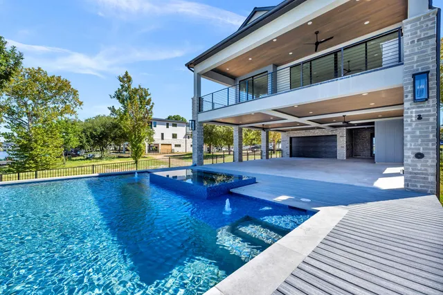 a view of a house with swimming pool and sitting area