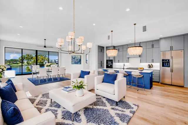 a living room with kitchen island furniture and a chandelier