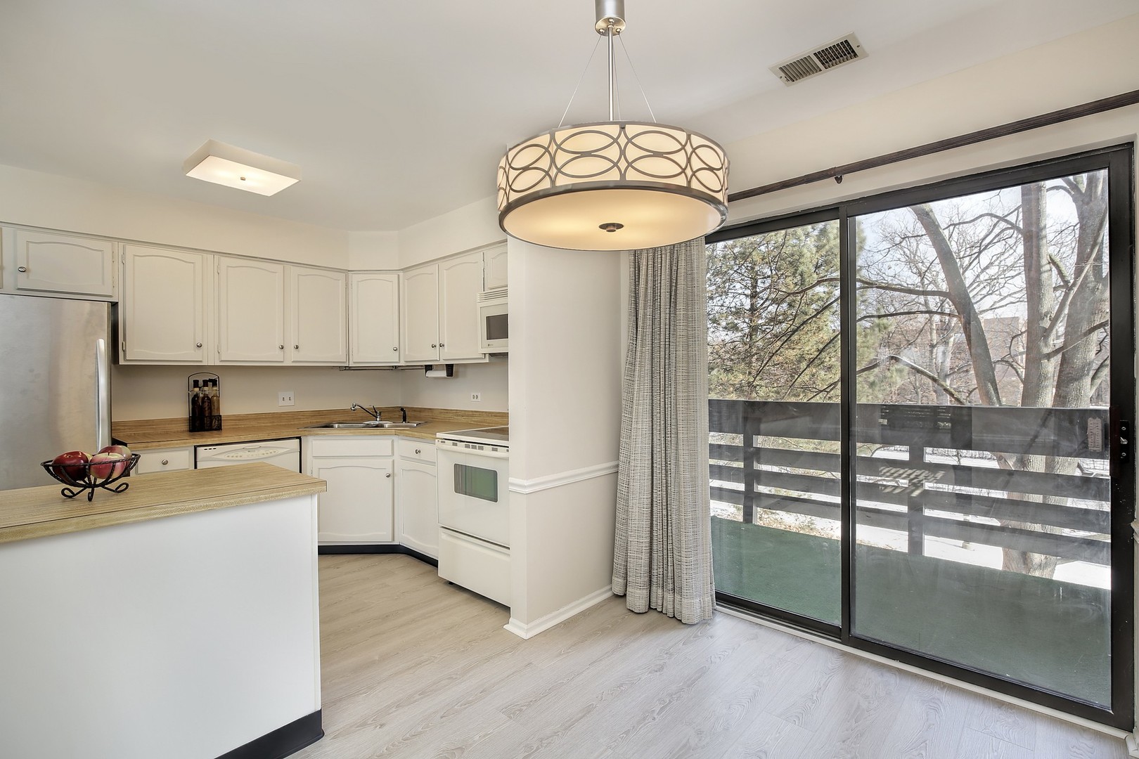 1088 Shermer Road, Unit 208 Northbrook, IL 60062 - Photo 8 of 15 a kitchen with a refrigerator a stove cabinets and a dining table