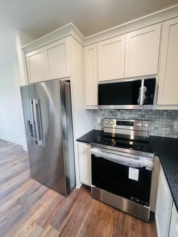 a kitchen with a sink a counter and cabinets