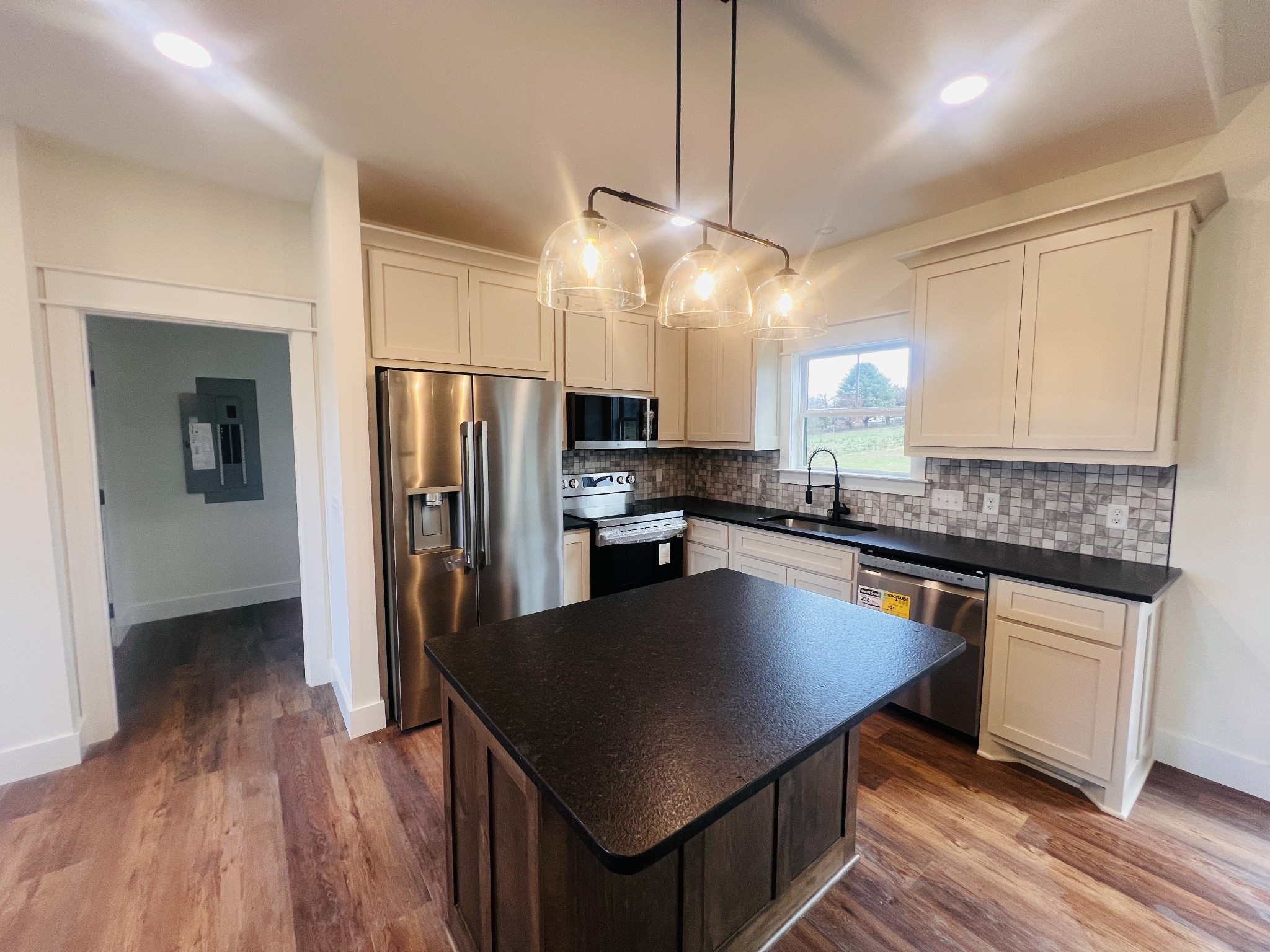 1769 Viola Road McMinnville, TN 37110 - Photo 15 of 28 a kitchen with granite countertop a center island stainless steel appliances and wooden floor