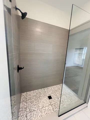 a bathroom with a granite countertop shower mirror and a sink