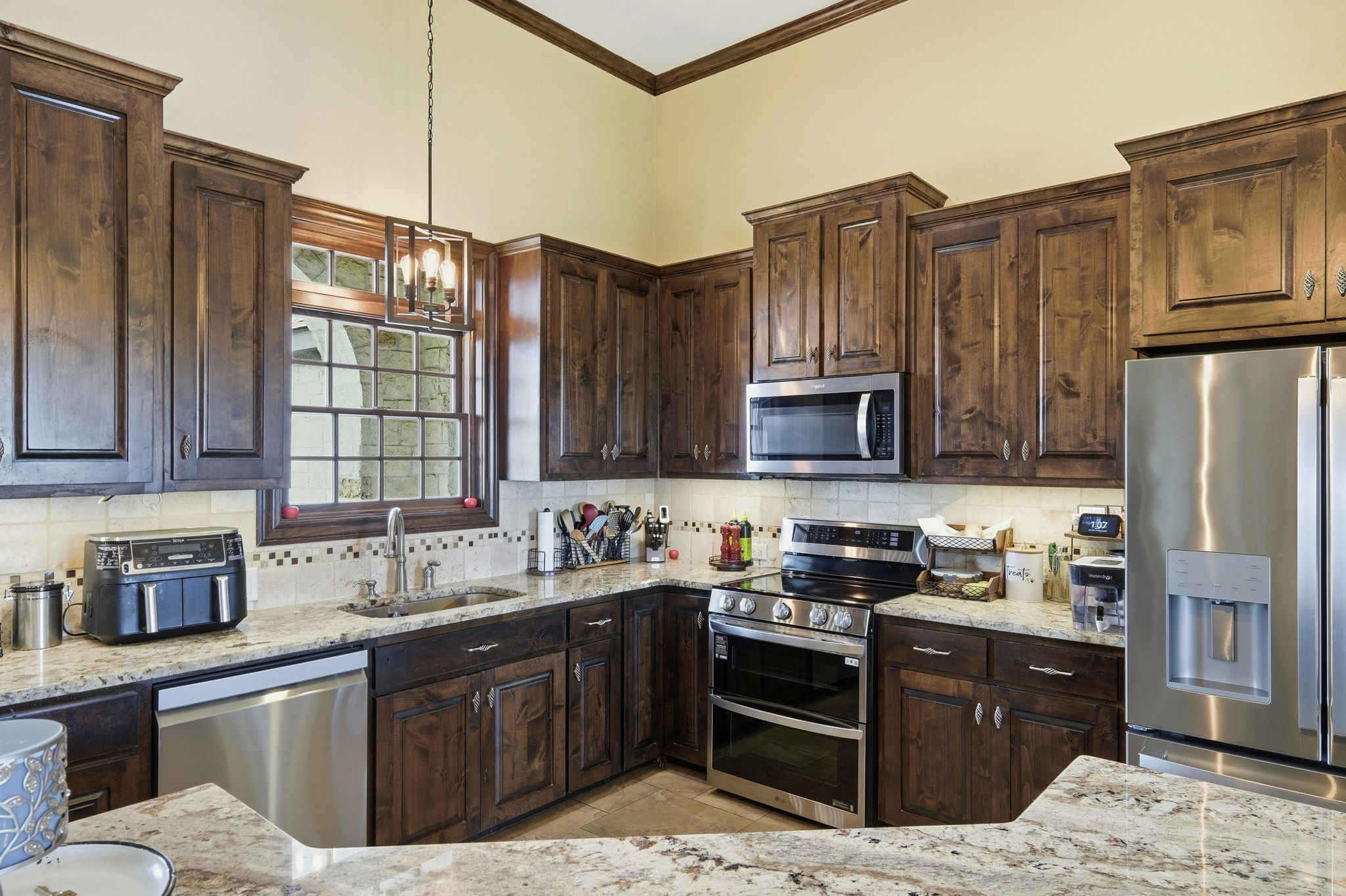701 County Road 107 Georgetown, TX 78626 - Photo 15 of 30 a kitchen with stainless steel appliances granite countertop a refrigerator stove top oven and sink