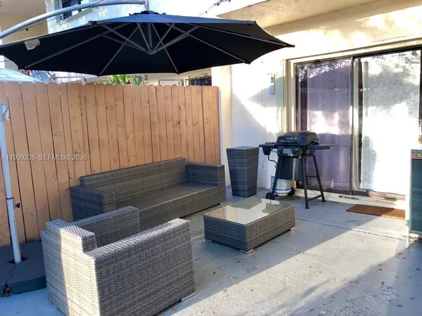 a living room with furniture and a umbrella