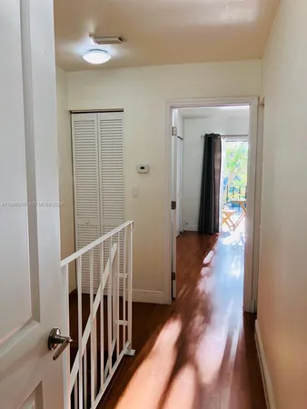 a view of hallway with wooden floor