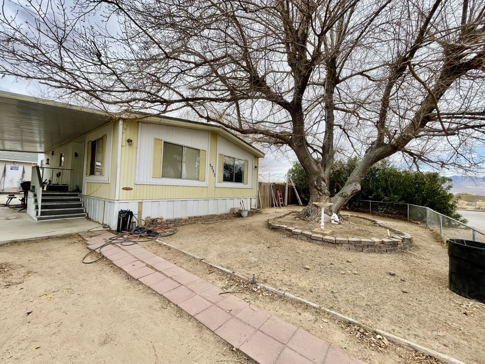 5237 Nolina Avenue Ridgecrest, CA 93555 - Photo 2 of 27 a front view of a house with a yard