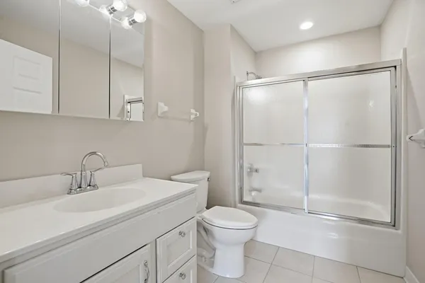 a bathroom with a toilet sink and shower