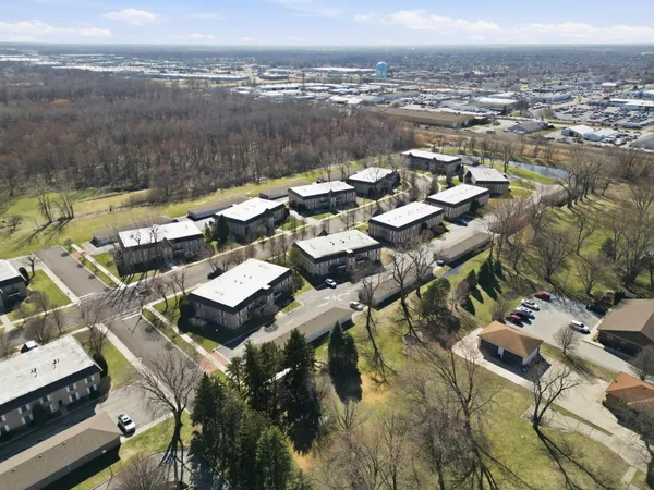an aerial view of a houses with a lake