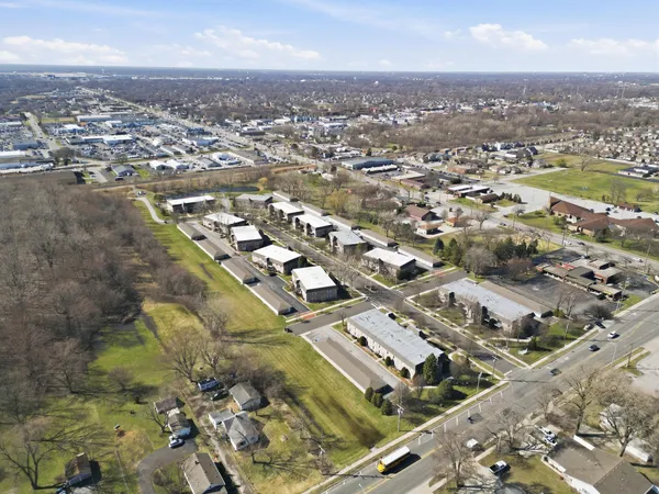 an aerial view of residential houses with city view