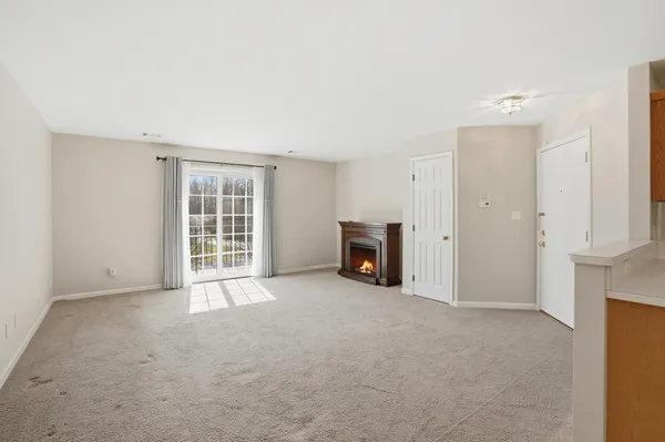 an empty room with furniture and a fireplace