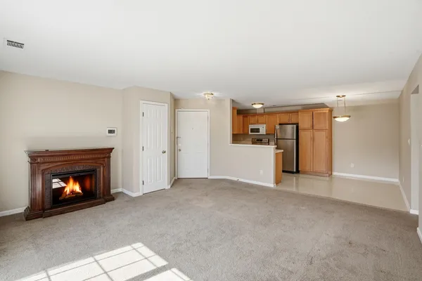 a view of an empty room with a fireplace