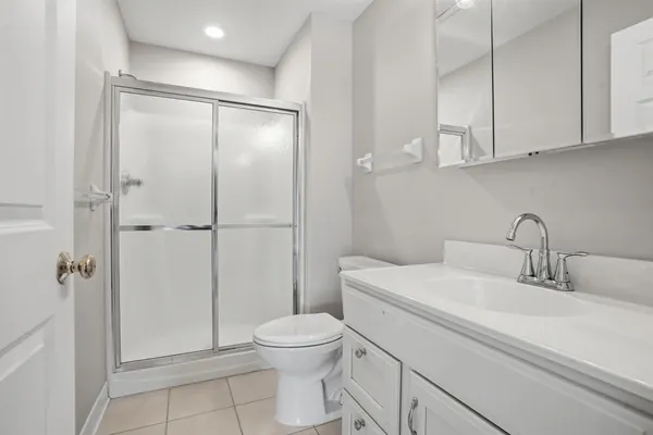 a bathroom with a toilet a sink and shower