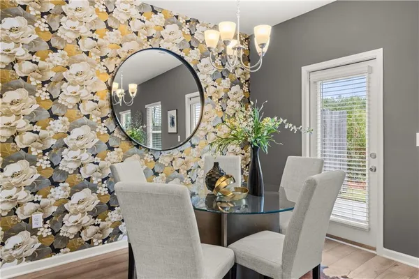 a living room with furniture a chandelier and a dining room