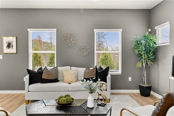 a living room with furniture and a potted plant