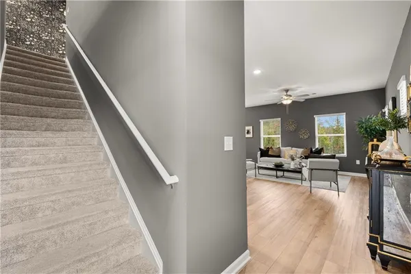a view of living room with granite countertop furniture and wooden floor