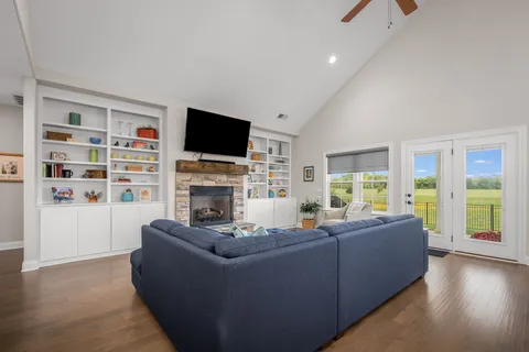 a living room with furniture a flat screen tv and a fireplace