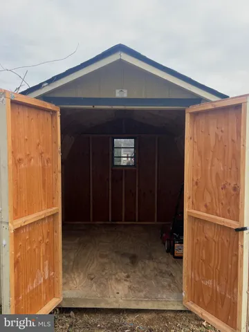 a house view with swimming pool in front of it