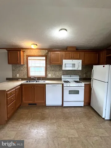 a large kitchen with a cabinets and white stainless steel appliances