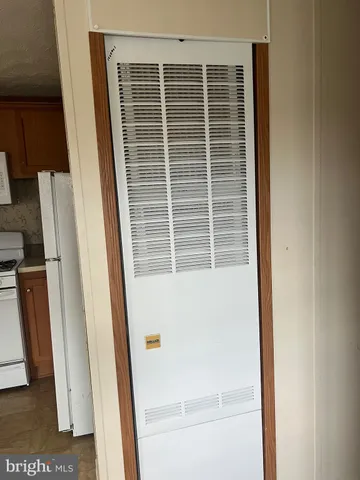 a view of a livingroom with wooden floor and a window