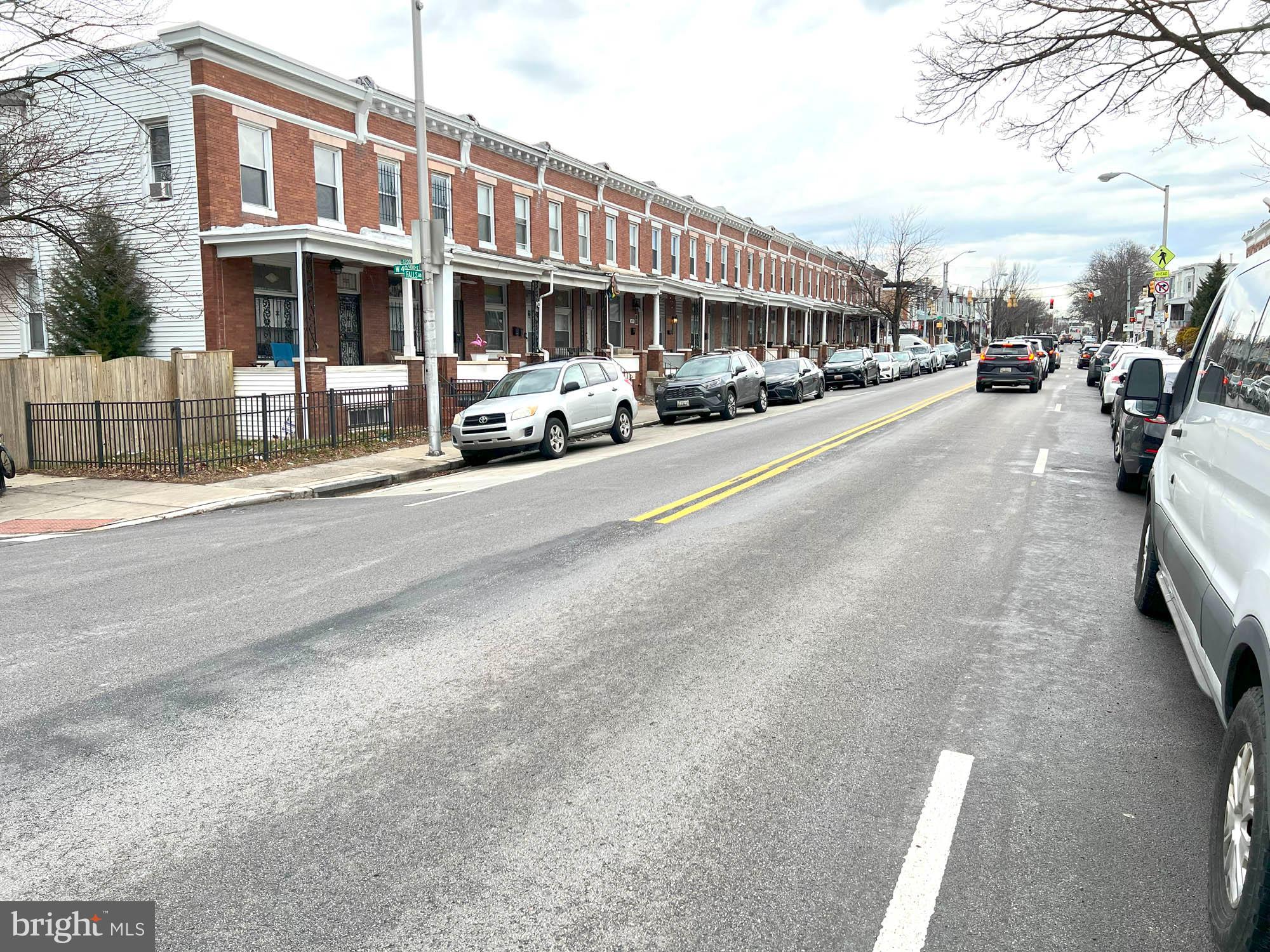 4013 Falls Road Baltimore, MD 21211 - Photo 6 of 7 a city street lined with buildings and cars