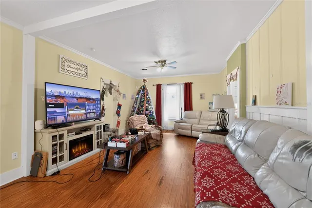 a living room with furniture flat screen tv and a fireplace