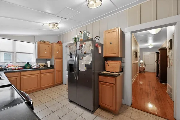 a kitchen with stainless steel appliances granite countertop a refrigerator and a stove