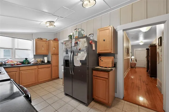 a kitchen with stainless steel appliances granite countertop a refrigerator and a stove