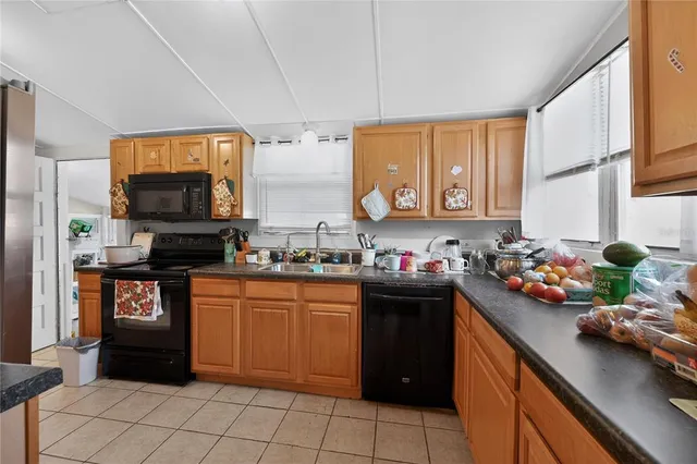 a kitchen with a sink cabinets and appliances