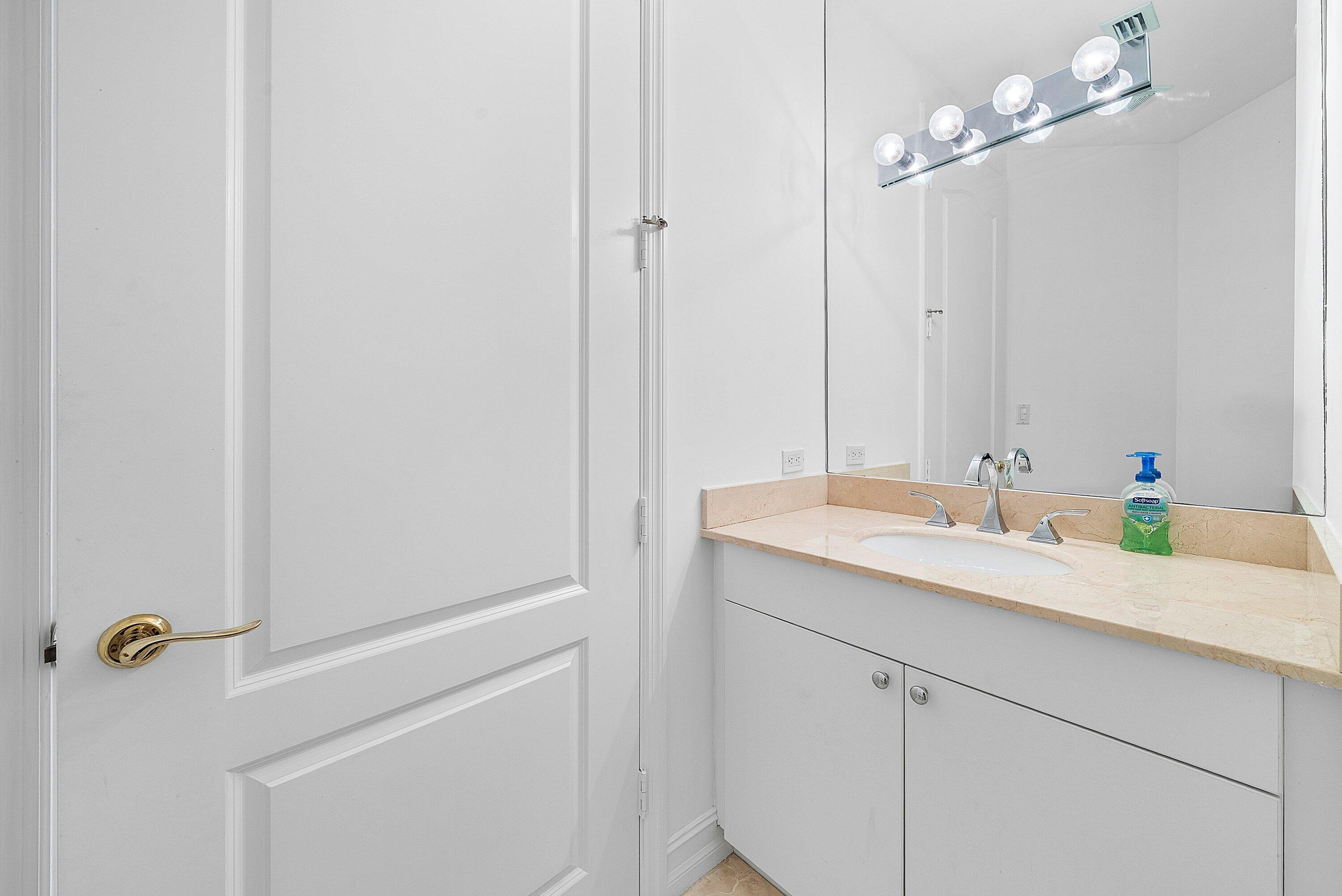 550 Southeast Mizner Boulevard, Unit B906 Boca Raton, FL 33432 - Photo 23 of 59 a bathroom with a sink and a mirror