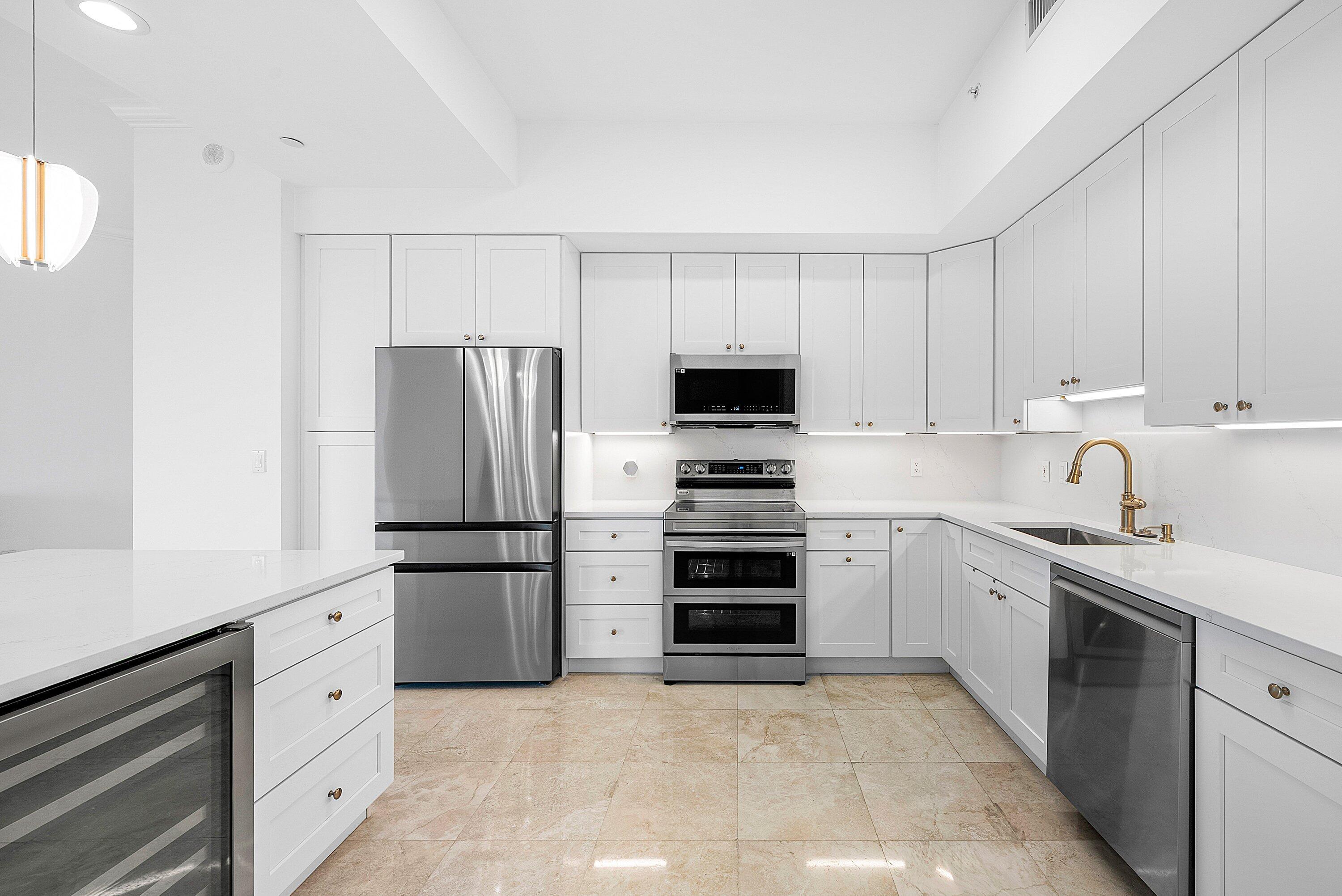 550 Southeast Mizner Boulevard, Unit B906 Boca Raton, FL 33432 - Photo 9 of 59 a kitchen with stainless steel appliances white cabinets and a refrigerator