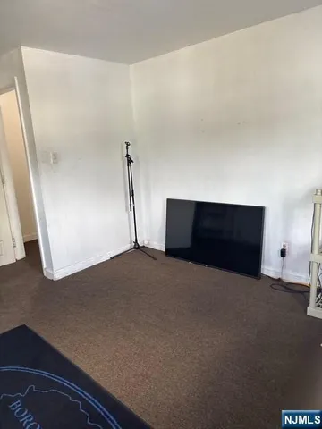 a living room with a couch and a potted plant