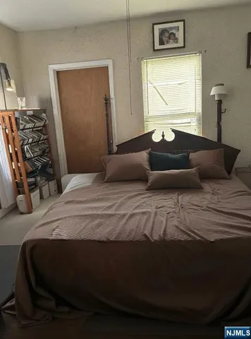 a bedroom with a bed and a closet