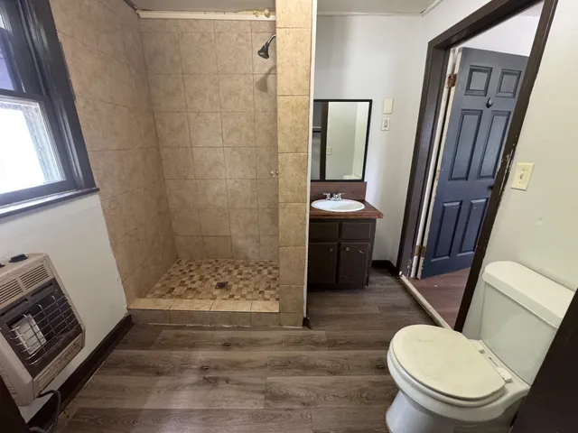 a bathroom with a toilet and a shower