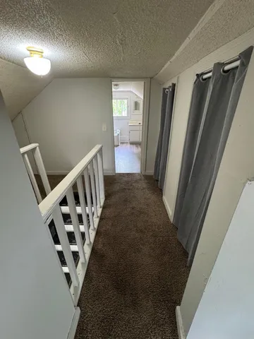 a view of a hallway with staircase