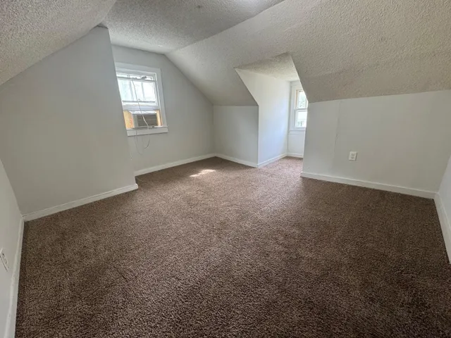 an empty room that has a window in it