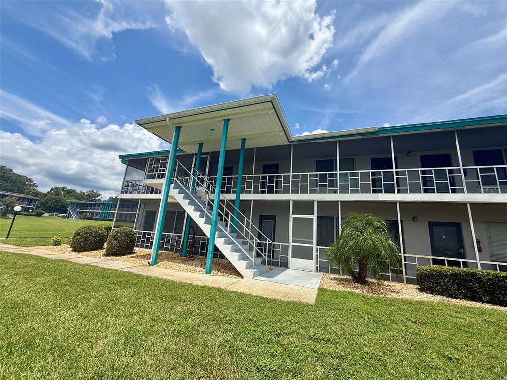 a view of a house with a swimming pool and a yard
