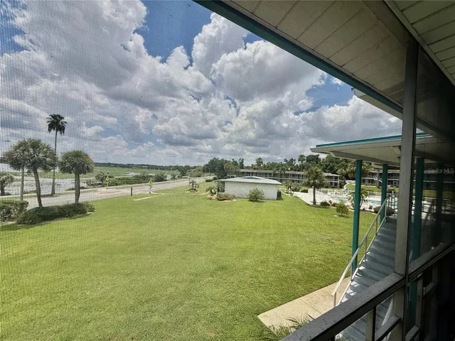 a view of a house with a swimming pool and a yard