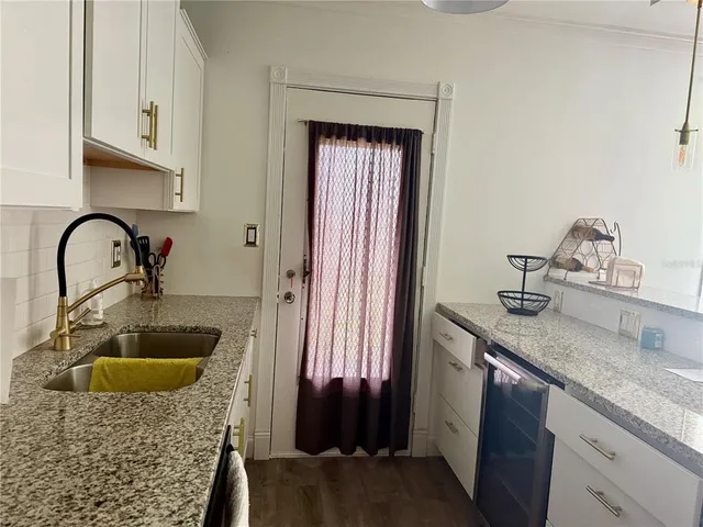 a bathroom with a granite countertop sink a granite counter and a sink