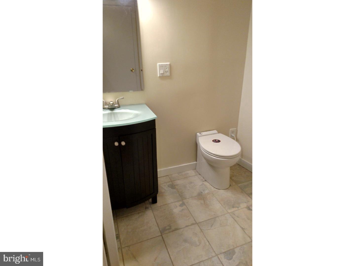 1005 South 8th Street Philadelphia, PA 19147 - Photo 12 of 13 a bathroom with a sink and a toilet