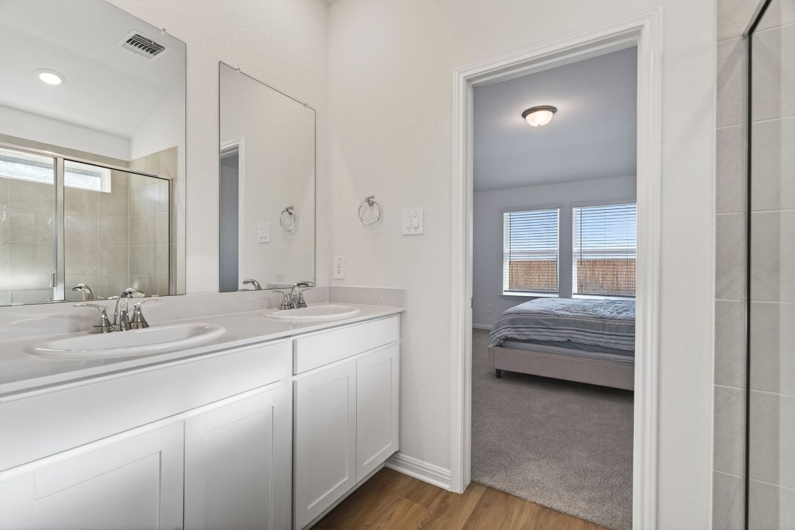 120 Honey Bee Road Jarrell, TX 76537 - Photo 11 of 20 a en suite bathroom with a double vanity sink and a mirror