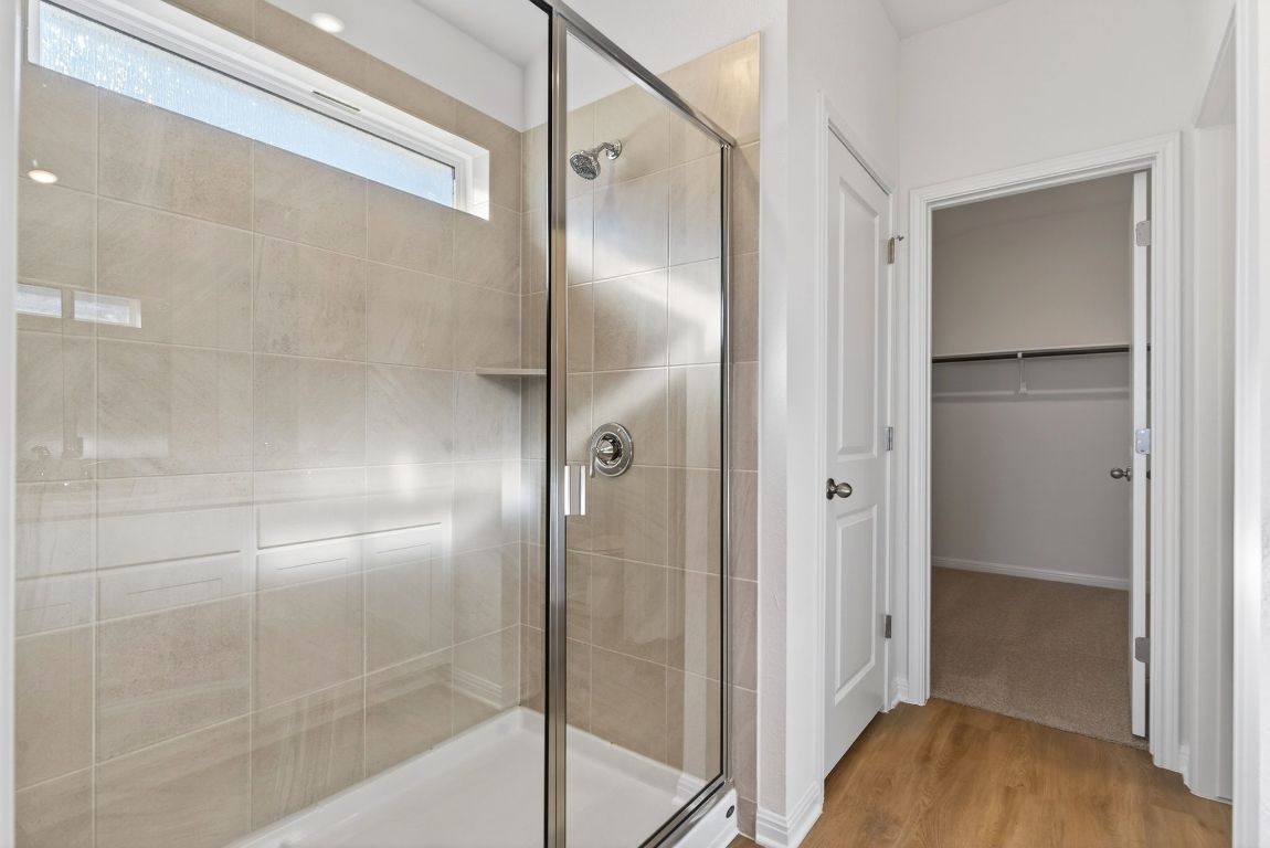 120 Honey Bee Road Jarrell, TX 76537 - Photo 13 of 20 a bathroom with a glass shower door