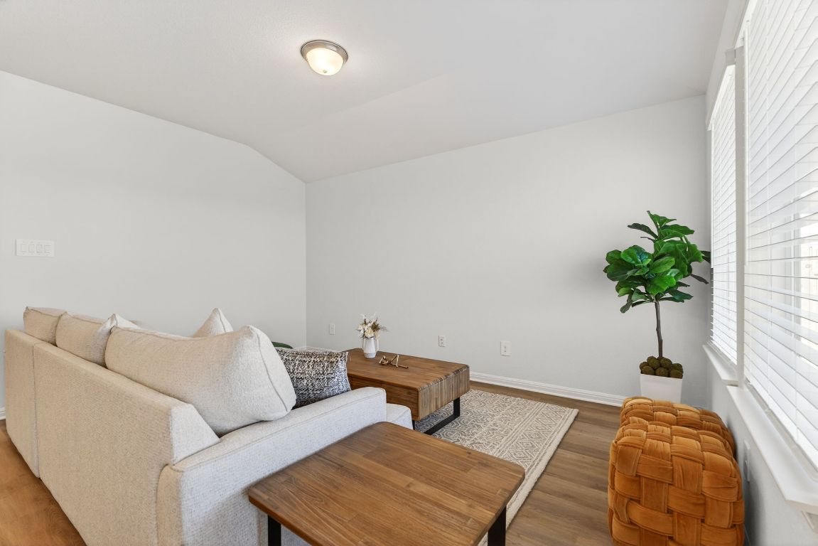 120 Honey Bee Road Jarrell, TX 76537 - Photo 3 of 20 a bedroom with furniture and a potted plant