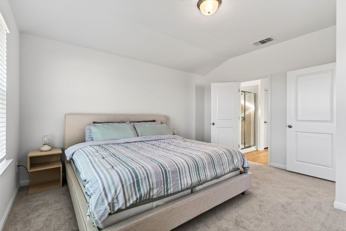 120 Honey Bee Road Jarrell, TX 76537 - Photo 10 of 20 a bedroom with a bed and a lamp