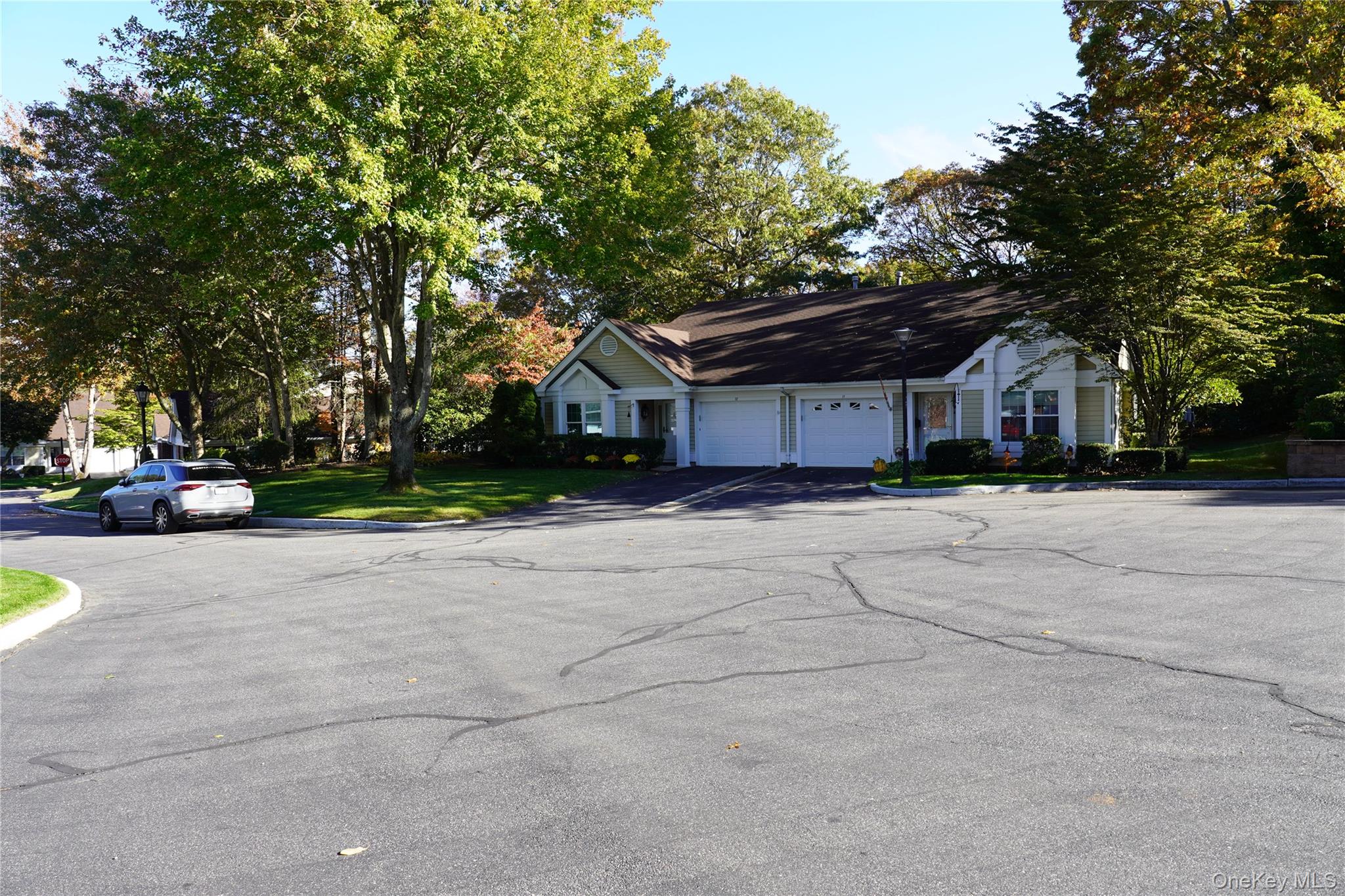 12 Baldwin Court Ridge, NY 11961 - Photo 2 of 15 a front view of a house with a yard and a bike