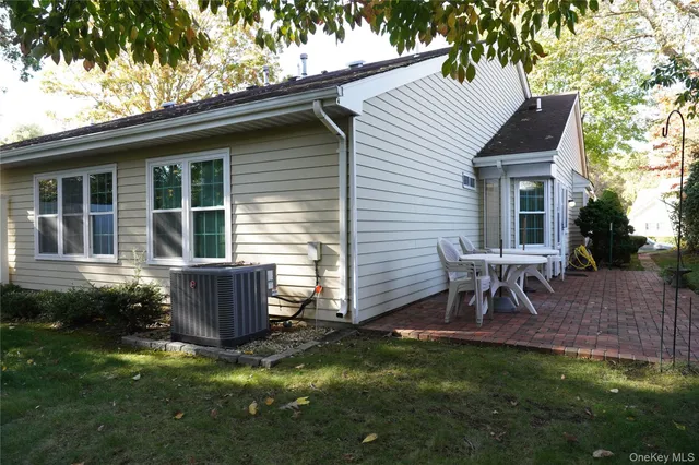 a view of house with backyard and sitting area