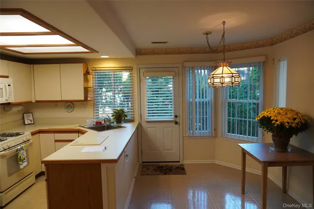 a kitchen with a refrigerator and a stove top oven