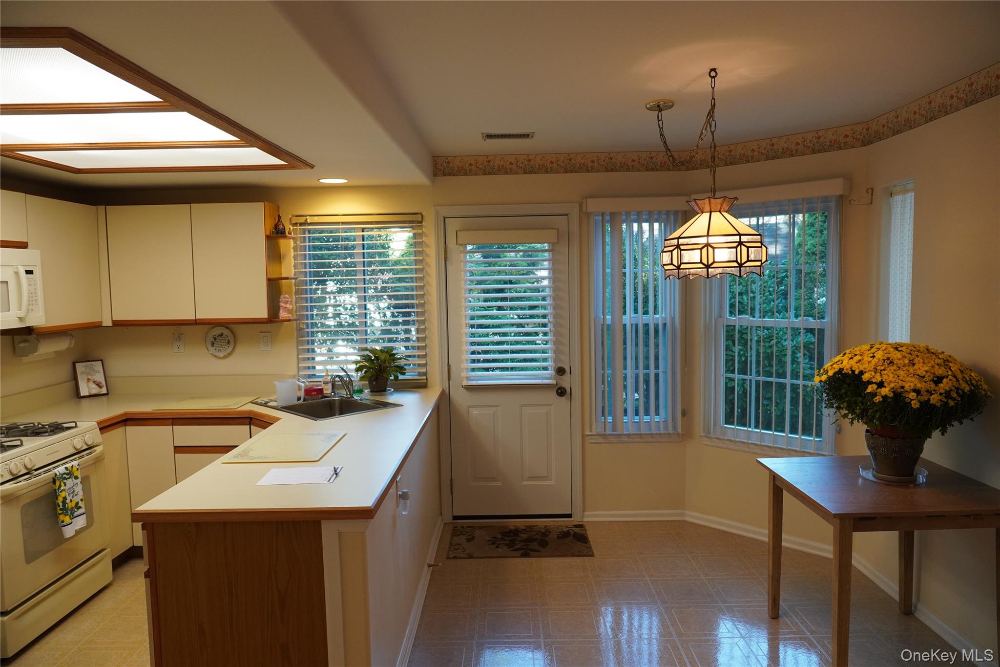 12 Baldwin Court Ridge, NY 11961 - Photo 9 of 15 a kitchen that has a sink and a stove